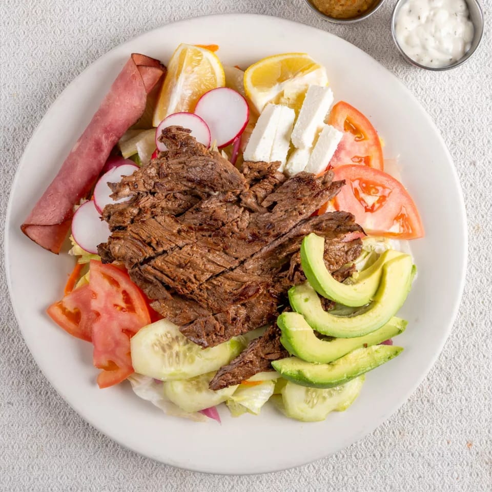 Montecristo Taqueria y Pupuseria's carne asada with avocado, tomatoes, radishes, cheese, and lemon.